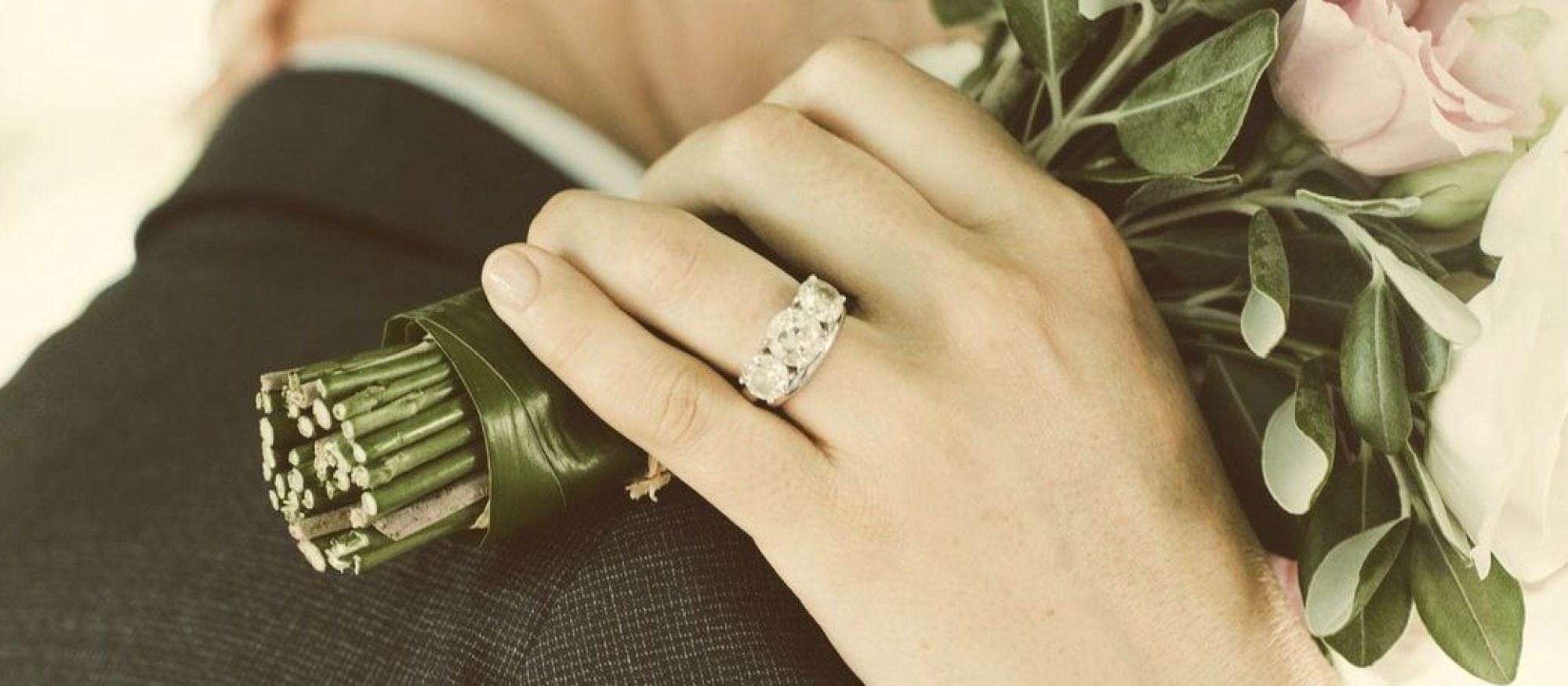 A bride wearing a bespoke engagement ring by Racine Jewels